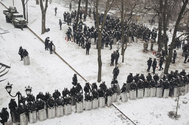 Police protects governmental district in Mariinsky park near stadium, where protesters burned tires. Kyiv, Jan. 21, 2014.