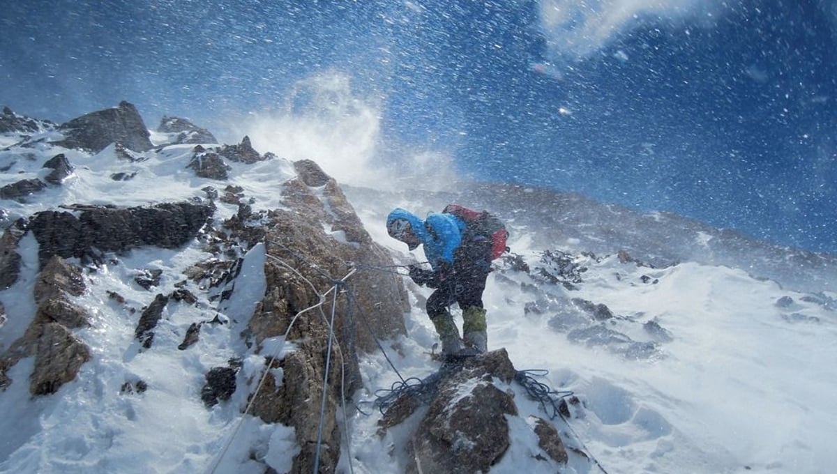 Buffeted by stinging blasts of wind-driven snow, Gerlinde Kaltenbrunner checks the ropes the team has spent weeks fixing along the entire route—9,000 feet of rope in all. From the October 125th anniversary issue of National Geographic magazine © Ralf Dujmovits/National Geographic