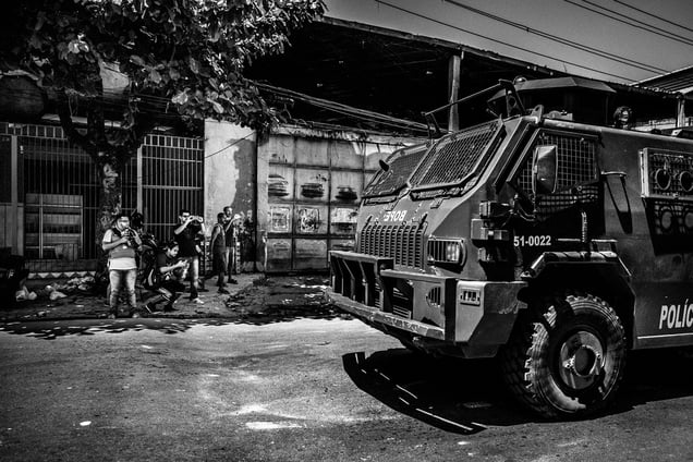 Papo Reto collective members taking pictures and videos of the Special Police Forces tank car patrolling in the streets of Vila Aliança after a taxi driver was shot by police; Rio de Janeiro, Brazil, 08 February 2015.