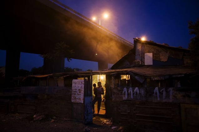 Smoke from a trash fire looms over the Nova Gazela settlement. © Matt Lutton
