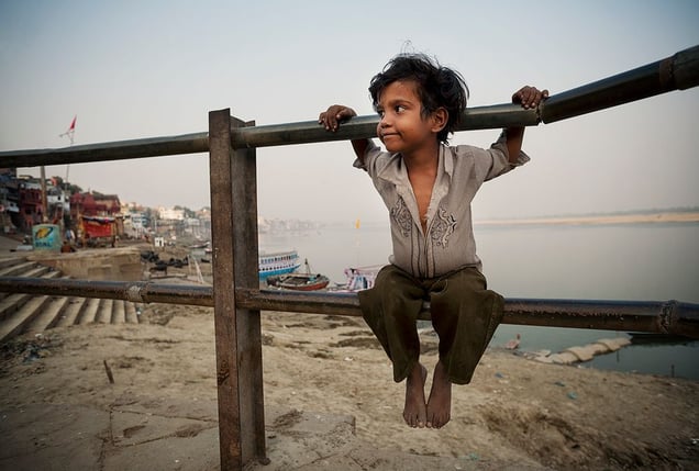 Varanasi, India: The boy is contently watching his herd of water buffalos that are resting on the ghats of the sacred river of Ganges. © Matjaz Krivic