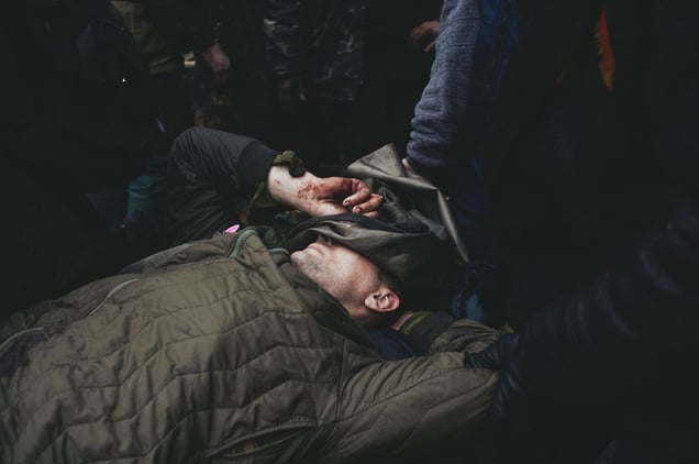 Protesters carry those who died of snipers, from hospital to Mikhailovska church, where relatives identify them. Kiev, Feb. 20, 2014.