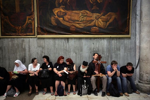 Jerusalem, Apr 08 - Christian pilgrims resting in the Holy Sepulcher church after taking part in Good Friday processions © Natan Dvir