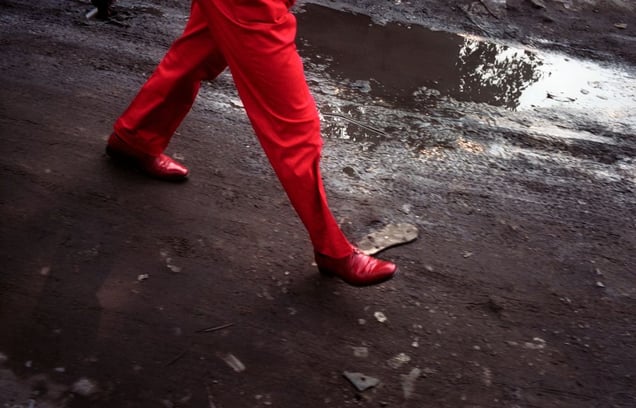 Willy Covary walks down a Bacongo street. Willy is a "sapeur"—a member of a Congolese social movement, La Sape, which is based around fashion. Sapeurs have a particular way of walking, with long, fast, self-confident steps. Willy, known as the "attacant du pointe" is one of the most famous sapeurs in Brazzaville, the capital. © Héctor Mediavilla
