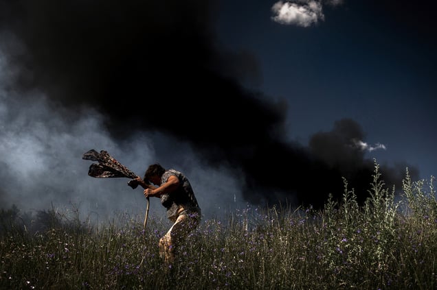 A woman escapes from a fire during a fire in Krasnodon highway