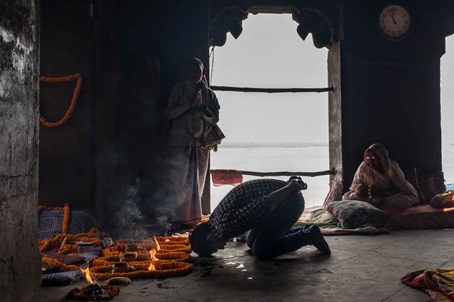 14. Shalu prays at the end of his shift. Whiskey , Bananas and cigarettes are part of the offering or Puja to Kalu Ram.
