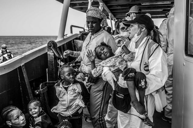 MOAS rescue team with an African child