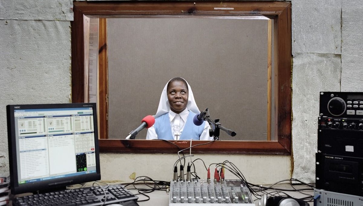 Men Kontre is the radio of the Catholic diocese of Les Cayes. Sister Melianise Gabreus is one of the stars of the radio. Even if there are no official figures, father Elysee, that runs the radio, says that lots of people tune in for Sister’s Melianise’s program on daily life advice. Les Cayes, Haiti. © Paolo Woods/INSTITUTE