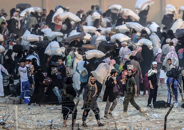 Islamic State members ask people to go back to city centre at the Turkish Akçakale crossing gate in Sanliurfa province, Turkey, 13 June 2015.