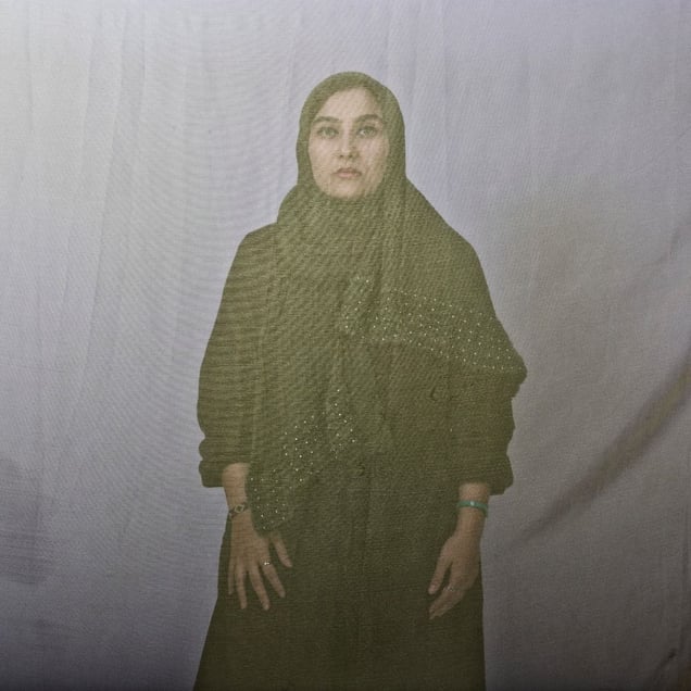 Sara, an Iranian woman is photographed through the fabric of her hijab (the Islamic headscarf worn by women in the presence adult men who are not members of her immediate family). Since the Islamic revolution in 1979, Iranian women are not allowed to be seen in public without proper Islamic head dress in Iran. Not wearing a proper hijab is illegal and can result in arrest by a special police unit,
