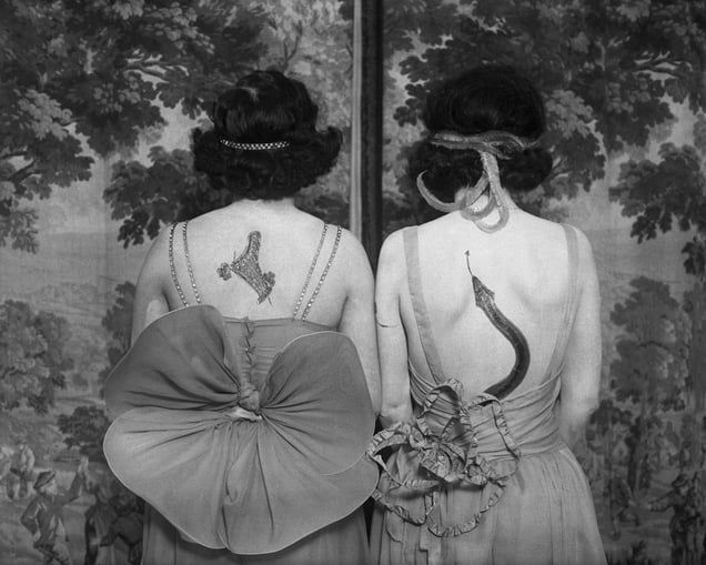Women wearing tattoos and costumes © CORBIS