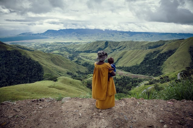 A woman looks down the valley from Kassam Pass, Morobe Province. The beautiful landscape of Papua New Guinea’s highlands belies the brutal reality of life in the region, where more than 90 percent of women report suffering gender-based violence.