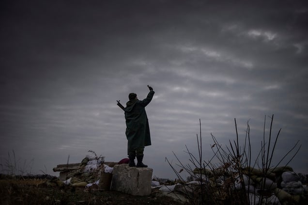 A rebel trying to catch a signal near the frontline