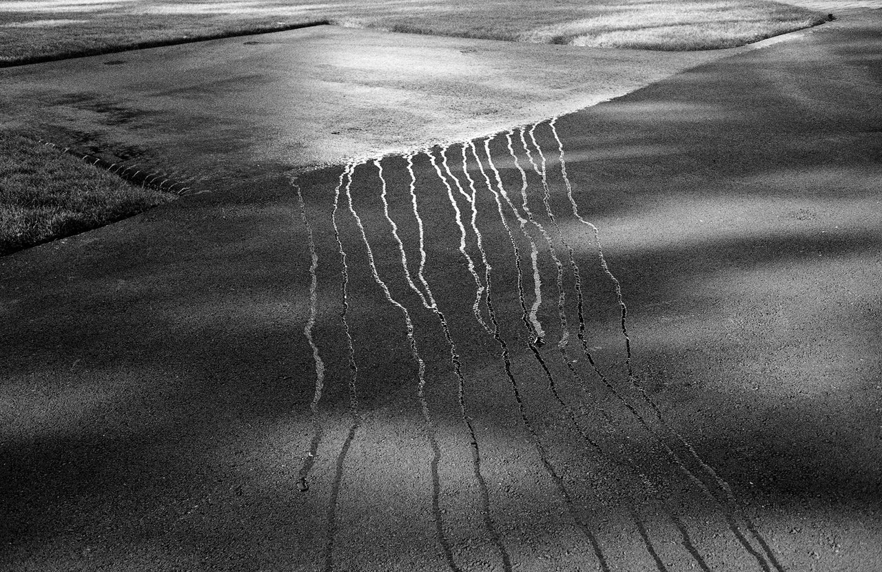 Sidewalk with Water © Alex Yudzon