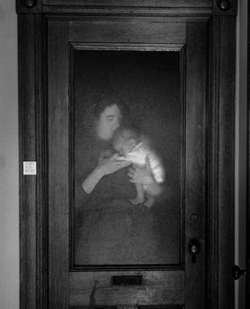 Lisa and Brady Behind Glass Door, 1986 © Abelardo Morell