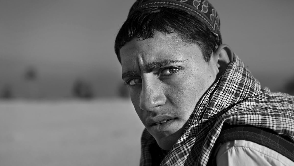 Rafiullah,15 years old. Shot at the home of his neighbor. Wounded in both legs and lost consciousness. From the series "Silent Night" © Lela Ahmadzai