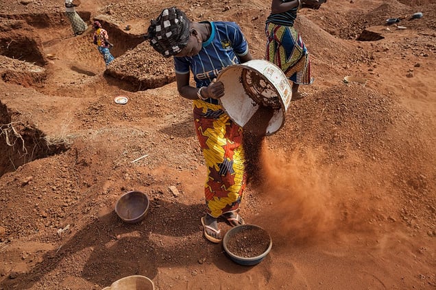 Women dig on the surface where they are repeatedly separating the heavier particles from dust, after which, they will pan it for gold. © Matjaz Krivic