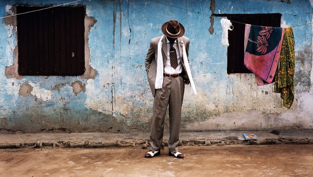 B. Mouzieto in Bacongo. The sapeur Bienvenu Mouzieto poses in front of his house in the Bacongo neighbourhood of Brazzaville, Congo. © Noorderlicht Photography