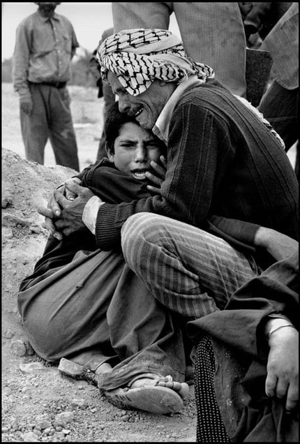 In Ahwaz cemetery, an uncle holds his nephew who lost his parents during the Iraqi bombardment  1981
© Copyright 1979-2009 Alfred Yaghobzadeh. All rights reserved.