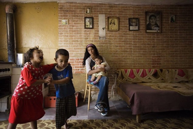 © Julie Denesha (United States) "Outcasts of Slovakia": Simonka Mirgova and Patko Polhous sing and dance as Sonja Polhousova cares for her nephew Adrian Pista in the home she shares with her parents and siblings. Honorable Mention, LensCulture Exposure Awards 2009