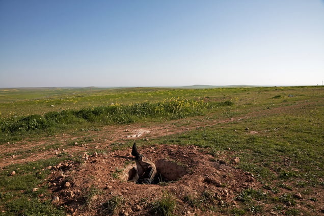 Dead body of Islamic state fighter left inside a small hole near the Eastern front of Kobane, Syria on 3 March 2015
