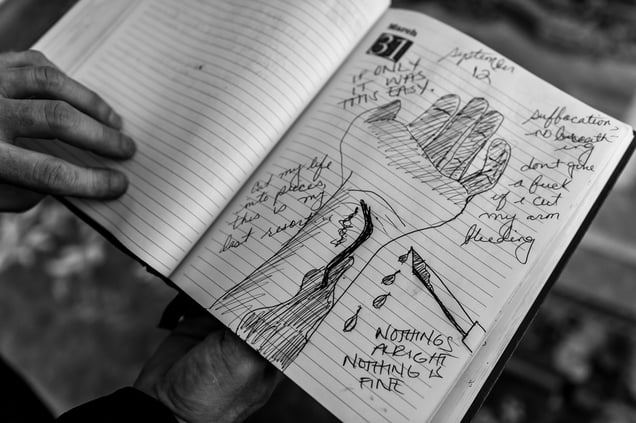 Gary Noling holds his daughter Carrie's journal on the anniversary of her suicide in Alliance, Ohio. Carrie Goodwin suffered severe retaliation after reporting her rape to her US Marine commanders. Five days after she was went home with a bad conduct discharge, she drank herself to death. Taken in Alliance, Ohio, US, 01 March 2014.