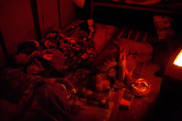 Ezidiar, Serdesht and Saïd sleep on the floor of the shipping container the family calls home. 19/02/15.