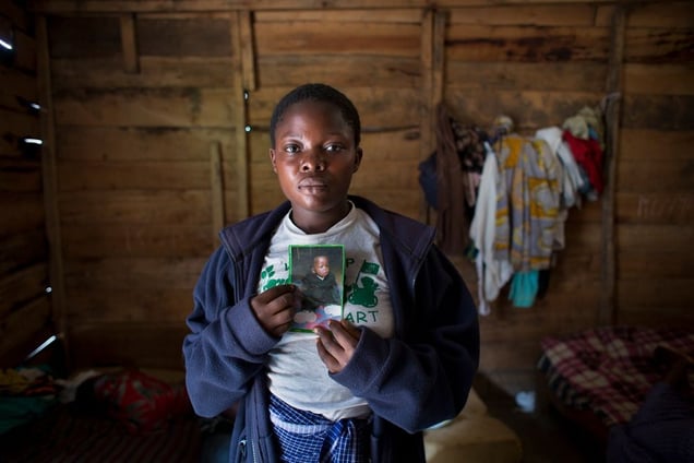 Micheline, now 18, held a picture of her son, Alain. She lived at the shelter for rape survivors when FARDC soldiers attacked. Her son had been conceived during the rape that landed her in the shelter.  Due to shame, it is not uncommon for a village to kick out a rape survivor. “When they pillaged, they also stole my son,” Micheline said. They found him later, so ill that he died a month later.