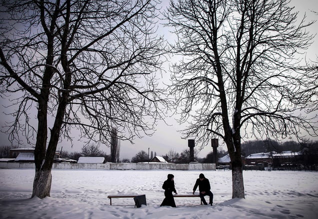 A couple on a date in the village of Serzhen-Yurt. Couples must meet in public and sit a distance from one another. All physical contact is forbidden before marriage.