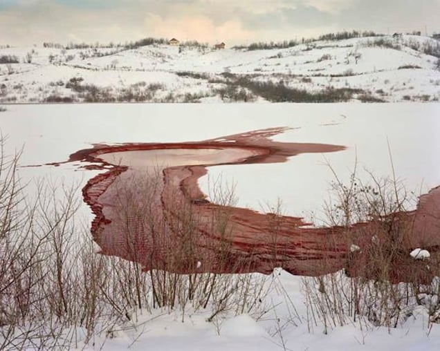 Aluminum waste pond at Petkovici, part of the Karakaj aluminum factory complex. In the afternoon and evening of 14th July 1995, hundreds of Bosniac men and boys were taken to the embankment of the dam that holds back the massive waste pond of the aluminum plant and executed. Some of their bodies are believed to have been thrown into the lake, others piled in mass graves. © Simon Norfolk