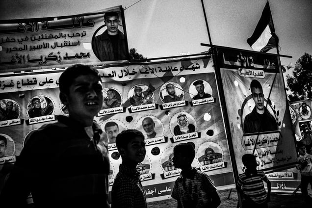 A poster featuring martyrs and fighters from Fatah at the welcome celebration for Mohammed Al Agha