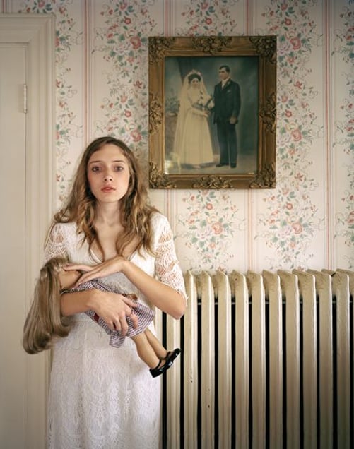 3rd Prize People, Observed Portraits Single © Ilona Szwarc, Poland, Redux Pictures. Kayla, Boston, USA. 19 February 2012, Boston, Massachusetts, USA. American Girl is a popular line of dolls that can be customized to look exactly like their owners. Kayla poses with her lookalike doll in front of a portrait of her ancestors.