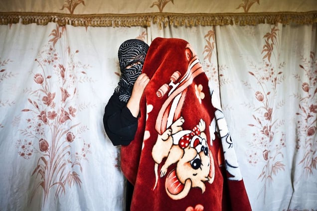 Jdeideh, Lebanon. Mona, 27 years old, comes from al Qusayr. She arrived in Lebanon three months ago with her husband and two small kids, after her brother-in-law got killed because he was a member of the Free Syrian Army. A former Arabic teacher, now Mona spends most of her day at home, looking after her kids and waiting for the fall of the Syrian regime. © Matilde Gattoni