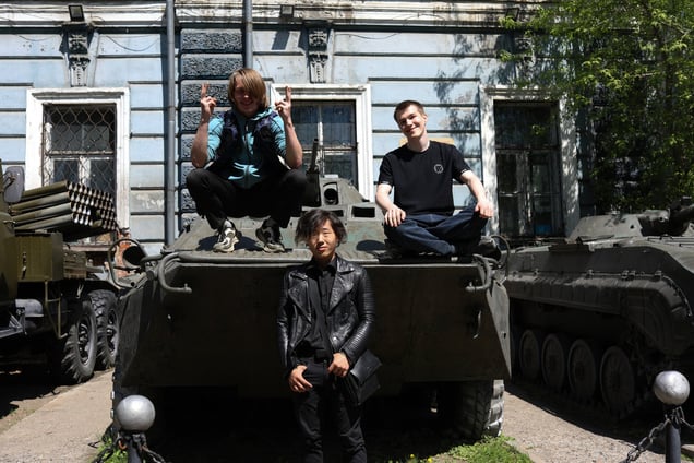 A university student from Odesa, Ukraine (left), who moved to Russia in 2014, poses with his Russian classmates in Irkutsk on May 18, 2024.