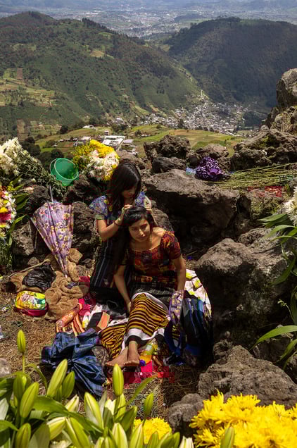 Locals on the Almolonga volcano, also called Cerro Quemado, in Guatemala. The ancient Maya believed that volcanoes were holy places where the Gods and spirits resided. Cerro Quemado is considered one of the best places to get close to the Gods. Thats why people come from all over the region to pray and perform ceremonies, bringing flowers and sometimes food and alcohol to leave as offerings to God and the ancestors. Some people also believe that Juan Noj, a supernatural Maya being lives in the volcano.