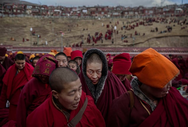Tibetan Buddhist nuns stand following a chanting session in Sertar county, Garze Tibetan Autonomous Prefecture, Sichuan province, China, 30 October 2015.