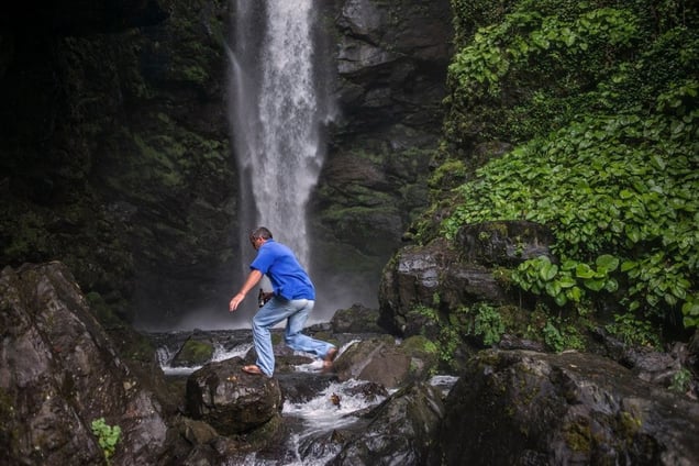 Georgia, Tkvarcheli, AbkhaziaA man jumps across rocks below a waterfall near the former mining town of Tkvarcheli.© Petrut Calinescu
