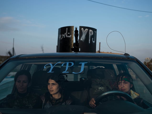 SYRIA. Serikani. Rojava. YPJ members sitting in an armed vehicle in Serikani.