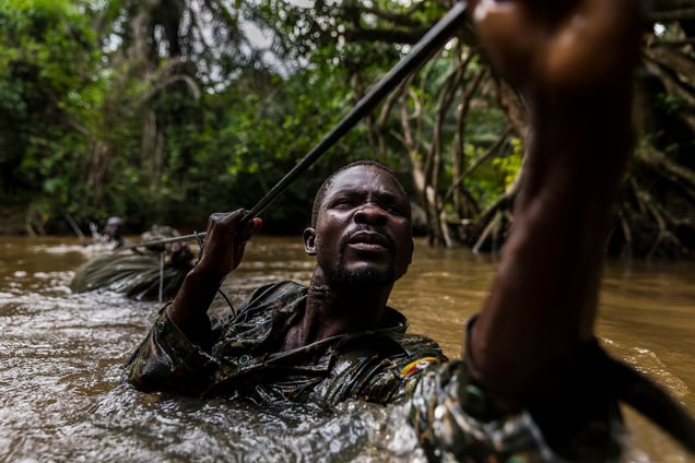 Ugandan soldiers cross a river while on patrol against the Lord’s Resistance Army close to the border of the DRC. Mbeki, Central African Republic, 26 November 2014.