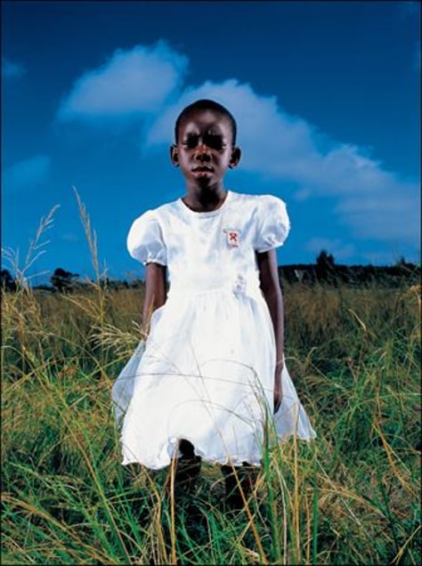 3rd prize Portraits Singles © Brent Stirton, South Africa, Getty Images for Global Business Coalition against Aids. Aids orphan, South Africa. A young Aids orphan stands in a field near Richards Bay, on the South African east coast. Both her parents are dead, and she is being cared for by members of her community.