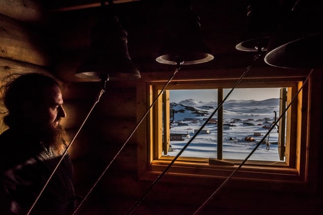 A priest looks on in the Bell room, after a vigil at the Russian Orthodox Church of the Holy Trinity; Fildes Bay, Antartica, 03 December 2015.