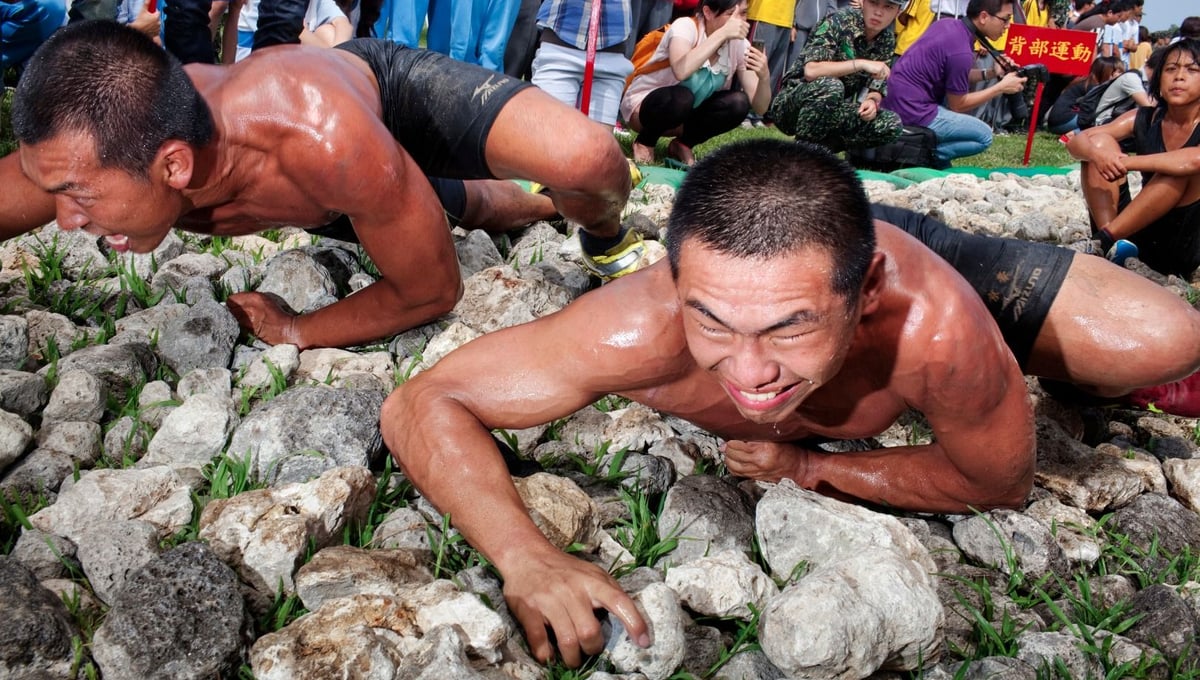 In the final test, the frogmen-to-be have to undergo their most difficult challenge: 'The Road to Heaven'. The conscripts crawl must crawl along a bed of sharp stones. © Touko Hujanen