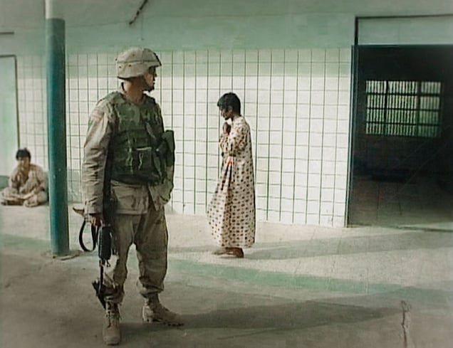 Baghdad, Iraq (2003). A US marine secures the Al Rashad psychiatric hospital, women ward.