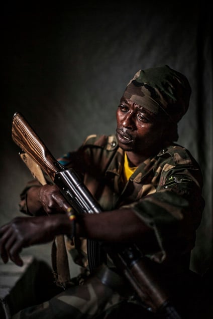 A Congolese solider sits for a portrait in a village in North Kivu province. His name and location have been purposefully withheld. © Pete Muller / PRIME