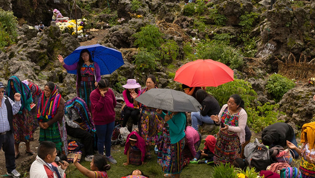 Locals and people across the region offering a prayer on the Almolonga volcano, also called Cerro Quemado, in Guatemala. The ancient Maya believed that volcanoes were holy places where the Gods and spirits resided. Cerro Quemado is considered one of the best places to get close to the Gods. Thats why people come from all over the region to pray and perform ceremonies, bringing flowers and sometimes food and alcohol to leave as offerings to God and the ancestors. Some people also believe that Juan Noj, a supernatural Maya being lives in the volcano.