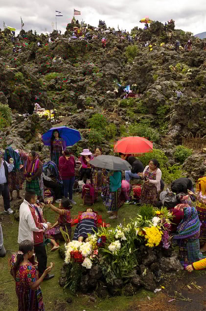 Locals and people across the region offering a prayer on the Almolonga volcano, also called Cerro Quemado, in Guatemala. The ancient Maya believed that volcanoes were holy places where the Gods and spirits resided. Cerro Quemado is considered one of the best places to get close to the Gods. Thats why people come from all over the region to pray and perform ceremonies, bringing flowers and sometimes food and alcohol to leave as offerings to God and the ancestors. Some people also believe that Juan Noj, a supernatural Maya being lives in the volcano.