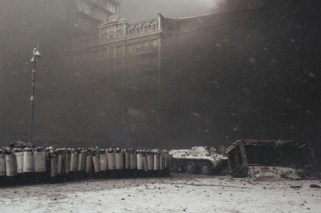 After the clashes with the protesters riot police protected APC which takes away burned buses from the carriageway in the center of Kiev on Jan. 22, 2014.