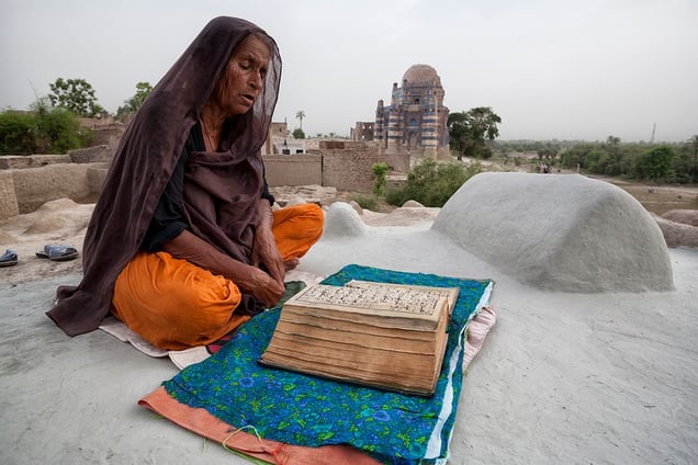 Uch Sharif, Pakistan: A woman praying on a grave of her husband. © Matjaz Krivic