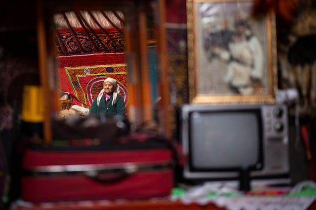 Portrait of a family elder amongst her few possesions.