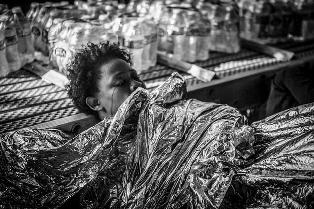 A young migrant weeps after being rescued